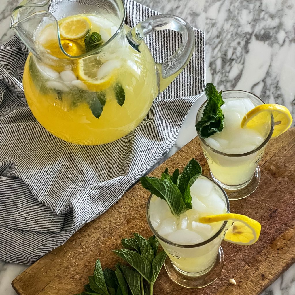 a pincher and two glasses of honey mint lemonade