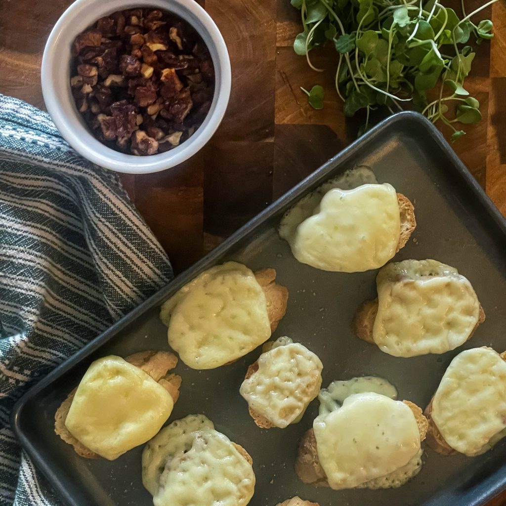 uncooked truffle honey fontina crostini in a pan