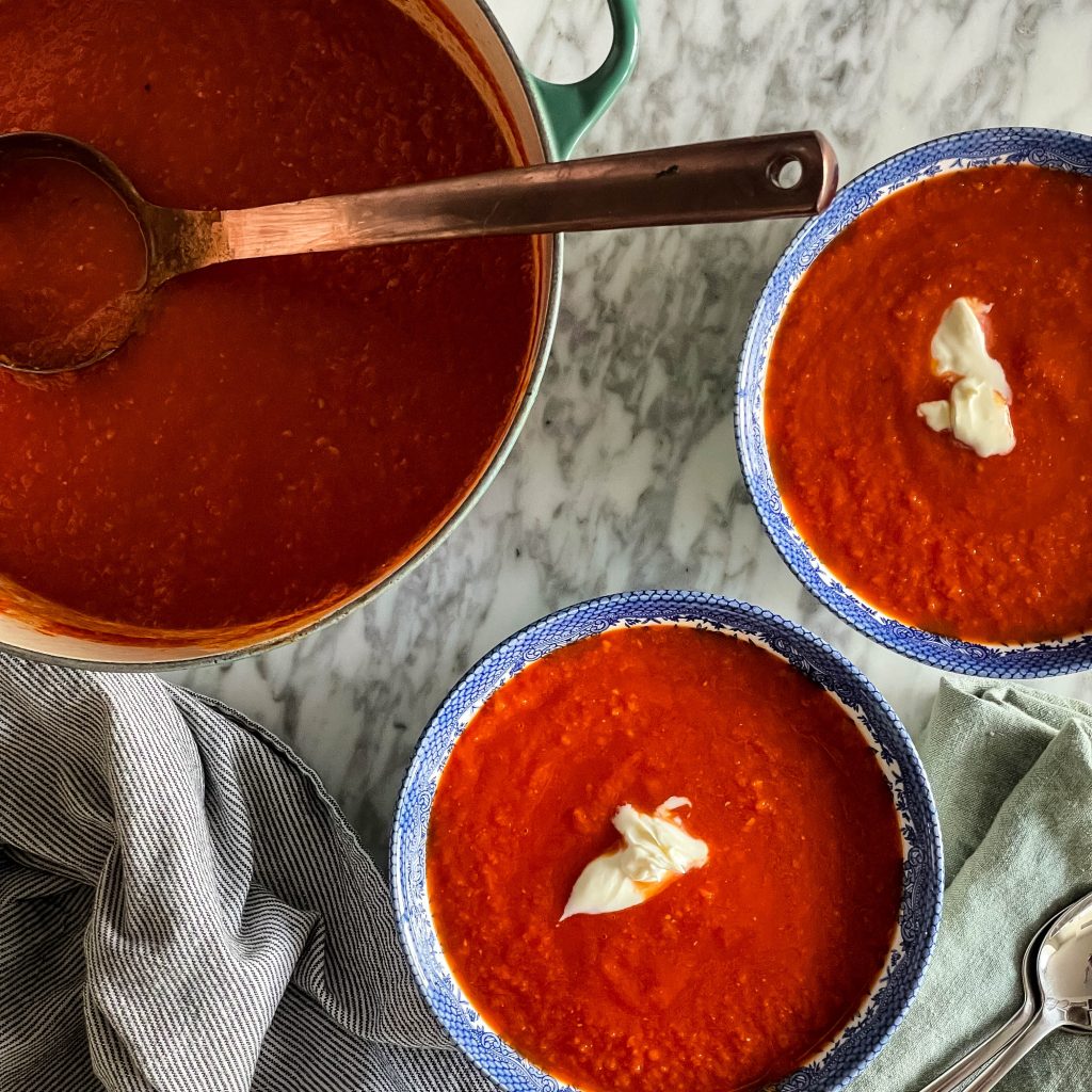 two bowls of tomato red pepper soup